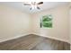 A bright bedroom with wood floors and a bright window view at 5815 Holmes Dr, Orlando, FL 32808