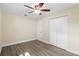 A large bright bedroom with wood floors, closet and ceiling fan at 5815 Holmes Dr, Orlando, FL 32808