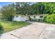Charming single-story home features a manicured lawn, long driveway, and attached one-car garage at 5815 Holmes Dr, Orlando, FL 32808