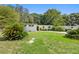 Charming single-story home with mature landscaping, including palm trees at 5815 Holmes Dr, Orlando, FL 32808