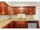 Close up of kitchen featuring updated cabinets, granite countertops, and stainless steel appliances at 5815 Holmes Dr, Orlando, FL 32808