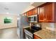 Kitchen featuring stainless steel appliances and dark wood cabinets at 5815 Holmes Dr, Orlando, FL 32808