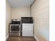 Small laundry area with dryer, oven, and microwave at 5815 Holmes Dr, Orlando, FL 32808