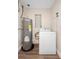 Laundry room features washer, hot water tank, and new flooring at 5815 Holmes Dr, Orlando, FL 32808