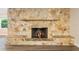 Living room with stone fireplace and wood floors at 5815 Holmes Dr, Orlando, FL 32808