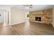 Bright living room features wood floors, stone fireplace and direct access to other rooms at 5815 Holmes Dr, Orlando, FL 32808
