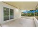 Back patio offers covered outdoor space with a glimpse of greenery beyond the backyard at 5815 Holmes Dr, Orlando, FL 32808