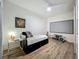 Bedroom featuring a bed, desk, and exercise equipment; ideal for a guest room or home gym at 6336 Buford St # 207, Orlando, FL 32835