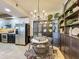 Cozy dining area with modern shelving and stainless steel appliances in the background at 6336 Buford St # 207, Orlando, FL 32835