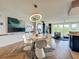 Bright dining area featuring modern lighting and a unique zebra-patterned rug beneath the table at 6336 Buford St # 207, Orlando, FL 32835