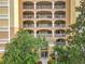 Elegant condo entrance with manicured landscaping, and beautiful balconies above at 6336 Buford St # 207, Orlando, FL 32835