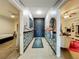 Hallway featuring modern decor, a stylish rug, and views into multiple rooms at 6336 Buford St # 207, Orlando, FL 32835
