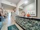 Inviting condo hallway with stylish decor, a large mirror, and views into various rooms at 6336 Buford St # 207, Orlando, FL 32835