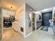 Stylish hallway with tile flooring, a closet, and decorative mirrors, leading to multiple rooms at 6336 Buford St # 207, Orlando, FL 32835