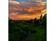 A dramatic sunset illuminates a tranquil landscape with vibrant colors at 6336 Buford St # 207, Orlando, FL 32835