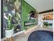 Living room featuring an electric fireplace and decorative plant wall at 6336 Buford St # 207, Orlando, FL 32835