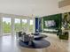 Airy living room with floor-to-ceiling windows and decorative green wall at 6336 Buford St # 207, Orlando, FL 32835