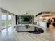 Bright living room with balcony access and a view of a modern kitchen at 6336 Buford St # 207, Orlando, FL 32835