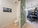 Half bath adjacent to a dining area featuring unique wallpaper and decor at 6336 Buford St # 207, Orlando, FL 32835