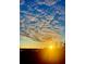 Sunrise over a horizon with patterned clouds and an intense sunlight at 6336 Buford St # 207, Orlando, FL 32835
