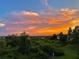 Expansive sunset vista with shades of blue and orange above mature trees and greenery at 6336 Buford St # 207, Orlando, FL 32835