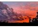 Stunning image of a fiery sunset with dramatic clouds filling the sky at 6336 Buford St # 207, Orlando, FL 32835