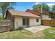 Exterior of home with tan siding, brown trim and patio area at 6809 Magnolia Pointe Cir, Orlando, FL 32810