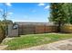 Fenced backyard with small storage shed and grass area at 6809 Magnolia Pointe Cir, Orlando, FL 32810