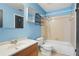 Bright blue bathroom with a bathtub and shower combination, vanity, and tiled floor at 6809 Magnolia Pointe Cir, Orlando, FL 32810