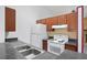 Standard kitchen with white appliances, gray counters and wood cabinets in a well lit room at 6809 Magnolia Pointe Cir, Orlando, FL 32810