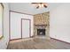 Cozy living room featuring a stone fireplace, white door, and wood-look floors at 6809 Magnolia Pointe Cir, Orlando, FL 32810