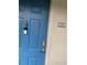 Blue front door featuring door bell, door knocker, and unit number 114 at 7360 Westpointe Blvd # 114, Orlando, FL 32835
