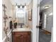Charming half-bathroom featuring modern fixtures, decorative accents, and convenient access to the entrance foyer at 7642 Park Hill Ave, Leesburg, FL 34748