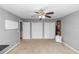 A spacious room offers closet storage, neutral walls, and a ceiling fan at 7642 Park Hill Ave, Leesburg, FL 34748