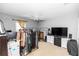 A bright bedroom features a ceiling fan and large window with rack storage for clothes at 7642 Park Hill Ave, Leesburg, FL 34748