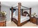 A primary bedroom features a regal four-poster bed with ornate wood carvings and matching bedroom set at 7642 Park Hill Ave, Leesburg, FL 34748