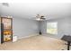 A flexible bedroom space features a ceiling fan, neutral walls, and large window to let in natural light at 7642 Park Hill Ave, Leesburg, FL 34748