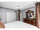 A spacious primary bedroom offers neutral walls, closet storage, decorative touches, and a regal wood carved four-poster bed at 7642 Park Hill Ave, Leesburg, FL 34748