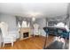 Cozy bonus room featuring a fireplace, comfortable seating, and exercise equipment for relaxation and fitness at 7642 Park Hill Ave, Leesburg, FL 34748