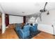Home theater with comfortable seating, a large screen, and a cozy fireplace for entertainment at 7642 Park Hill Ave, Leesburg, FL 34748