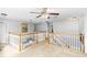 Spacious upper-level landing with views of the downstairs area, creating an open and airy atmosphere at 7642 Park Hill Ave, Leesburg, FL 34748