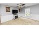 Cozy living room with a fireplace, neutral carpet, and a bright window offering natural light at 7642 Park Hill Ave, Leesburg, FL 34748