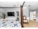 Another view of the main bedroom showcasing an upholstered chair, neutral walls, and elegant decor at 7642 Park Hill Ave, Leesburg, FL 34748