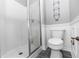 Bathroom featuring a modern stand-up shower with glass doors and modern fixtures at 7642 Park Hill Ave, Leesburg, FL 34748