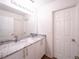 Bathroom featuring double vanity with stone countertop, mirror, and neutral paint at 8330 Lainie Ln, Orlando, FL 32818