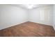 Bright bedroom with hardwood floors, neutral walls, ceiling fan, and a large window at 8330 Lainie Ln, Orlando, FL 32818
