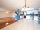Bright, open kitchen featuring white cabinetry, stainless steel appliances, and a view of the living area at 8330 Lainie Ln, Orlando, FL 32818