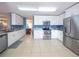 Modern kitchen featuring stainless steel appliances, granite countertops, white cabinets, and an open layout at 8330 Lainie Ln, Orlando, FL 32818