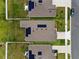 Aerial view of houses showcasing solar panels on the roofs, green lawns, and paved driveways at 884 Laurel View Way, Groveland, FL 34736