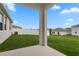 Green backyard showcasing healthy grass and a white fence in a neighborhood setting at 884 Laurel View Way, Groveland, FL 34736